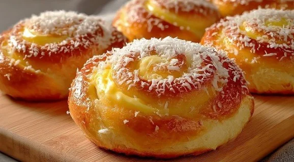 Delicious vanilla cream rolls with coconut filling on a plate
